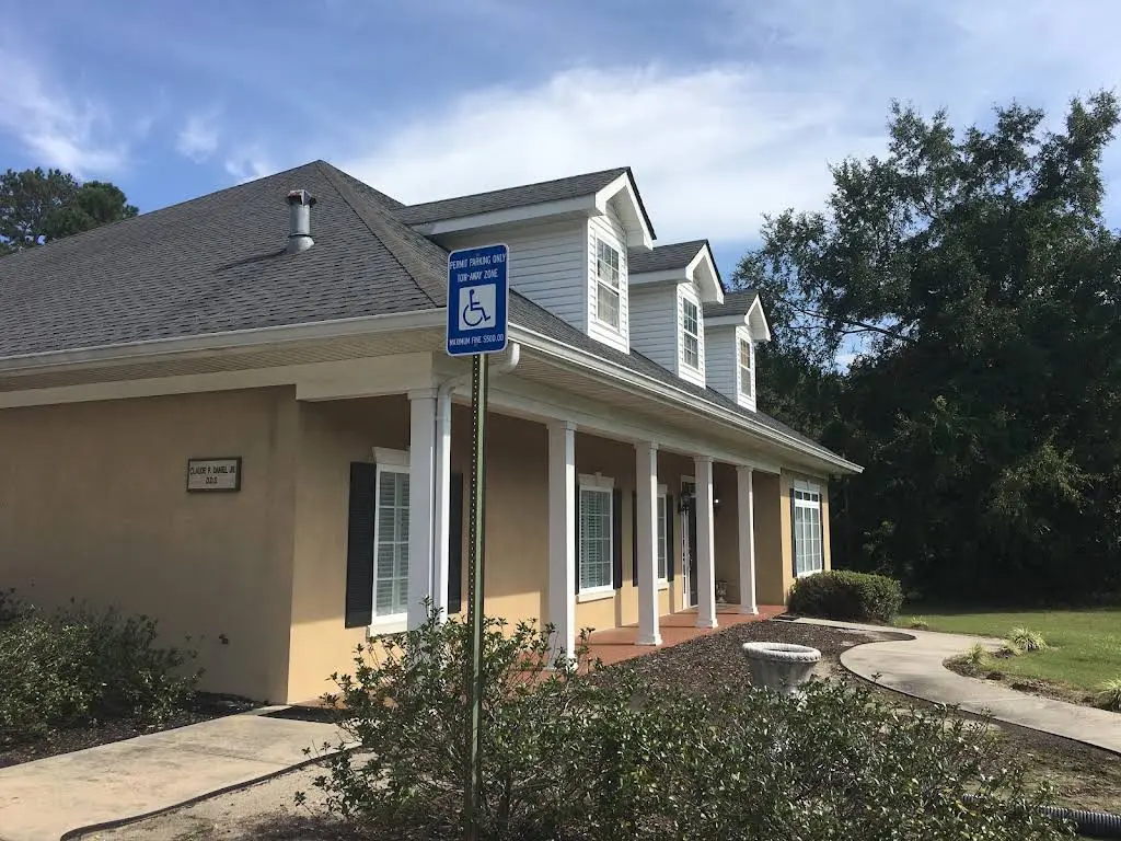 Claude P. Daniel, DDS - Professional dental clinic exterior with modern facilities