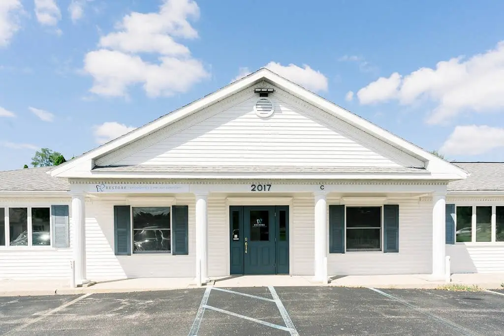 Restore Periodontics and Implants - Professional dental clinic exterior with modern facilities