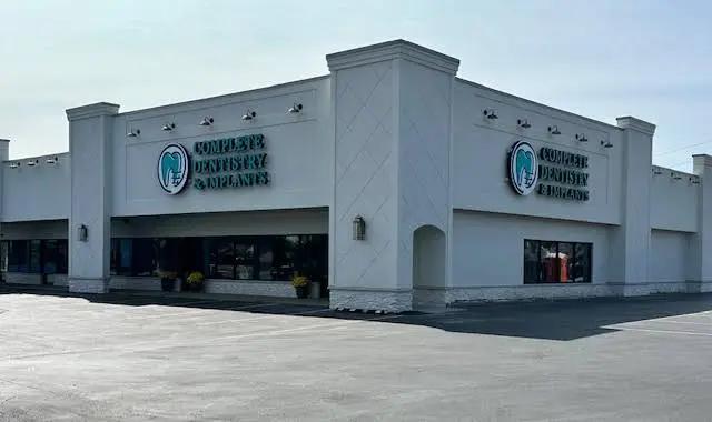 Complete Dentistry & Implants - Professional dental clinic exterior with modern facilities