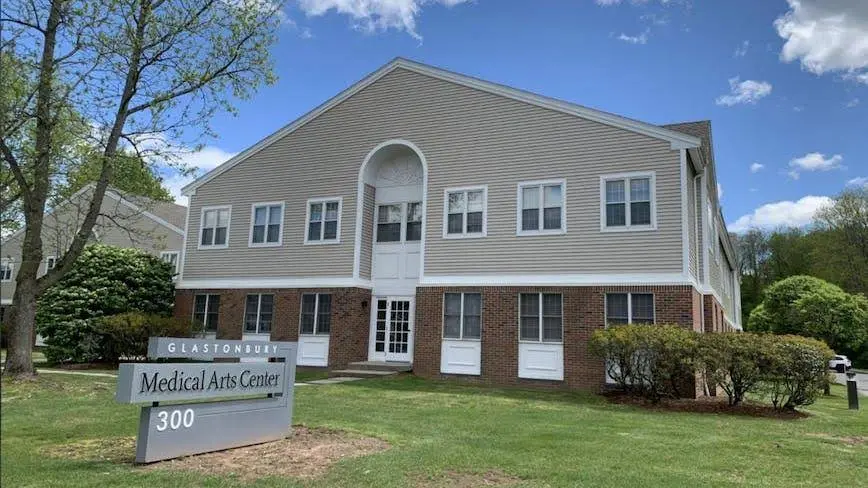 Advanced Cosmetic and Implant Dentistry - Professional dental clinic exterior with modern facilities