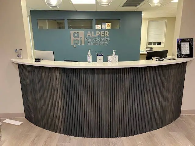 Alper Periodontics & Implants - Professional dental clinic exterior with modern facilities